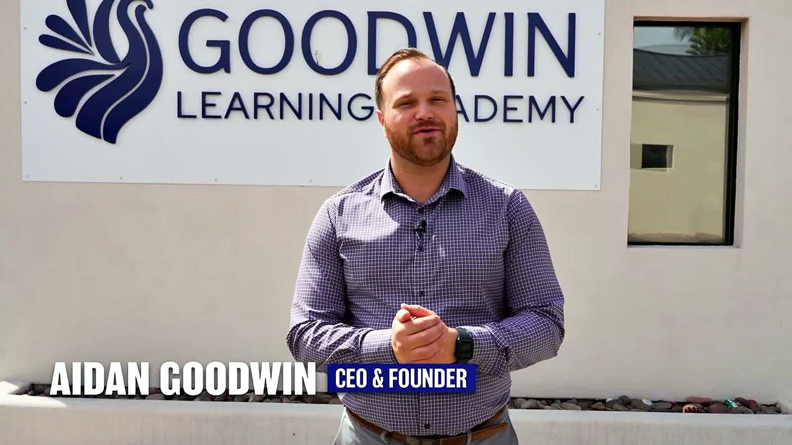 Aidan Goodwin, CEO and founder of Goodwin Learning Academy, in front of the school's sign